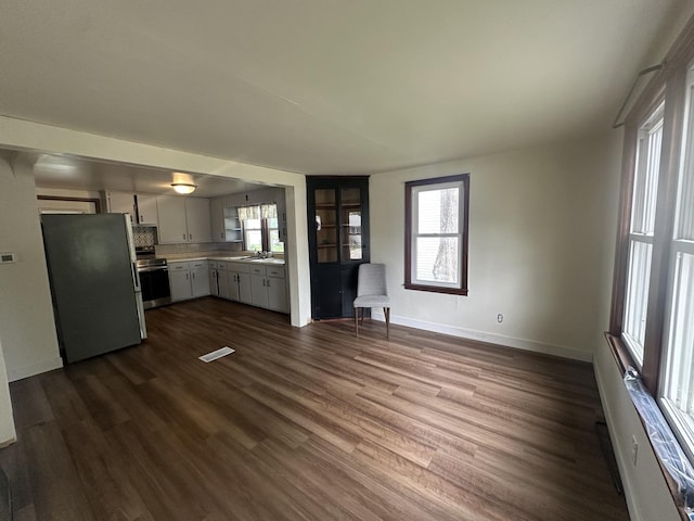 1506 17th Ave, Sterling, IL 61081 - unfurnished living room with dark wood-type flooring and plenty of natural light