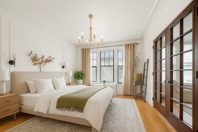 1040 Washington Blvd Unit 2, Oak Park, IL 60302 - bedroom with ornamental molding, a chandelier, light wood-type flooring, and french doors