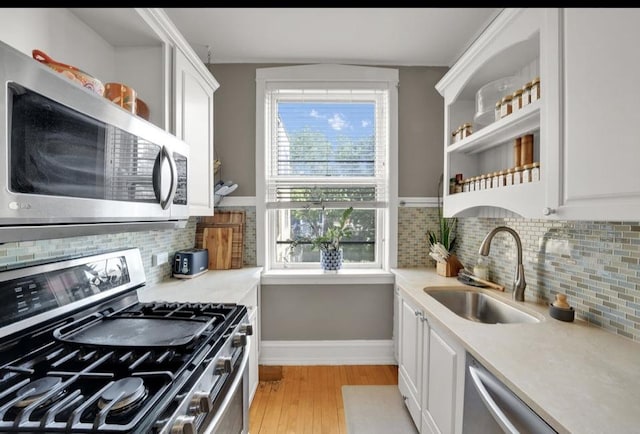 1040 Washington Blvd Unit 2, Oak Park, IL 60302 - kitchen featuring stainless steel appliances, open shelves, light wood finished floors, and healthy amount of natural light