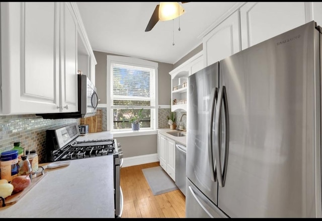 1040 Washington Blvd Unit 2, Oak Park, IL 60302 - kitchen with stainless steel appliances, decorative backsplash, white cabinetry, and light wood-style flooring