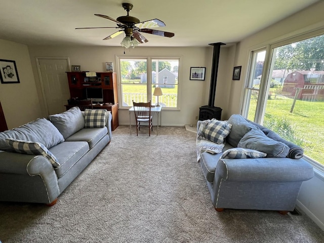 14 N Walnut St, Pesotum, IL 61863 - carpeted living room with a wood stove and ceiling fan