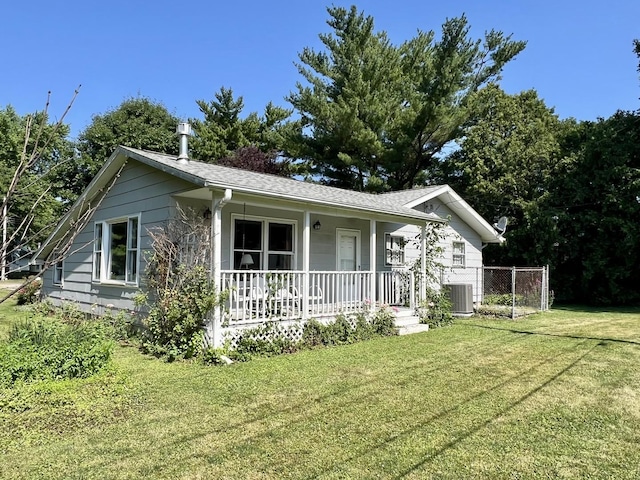14 N Walnut St, Pesotum, IL 61863 - view of front of home with covered porch, a front yard, and a shingled roof