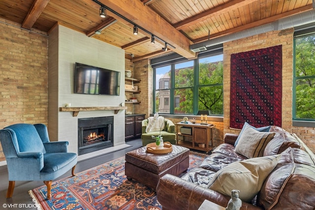 835 N Wood St Unit 301, Chicago, IL 60622 - living room with track lighting, a wooden ceiling with exposed beams, brick wall, and a large fireplace