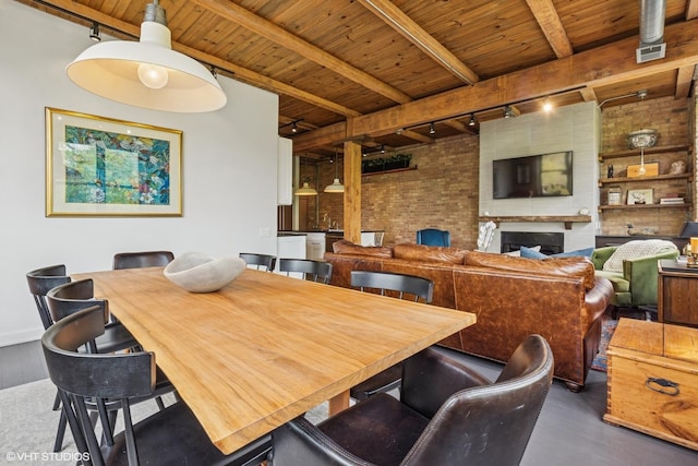 835 N Wood St Unit 301, Chicago, IL 60622 - dining room with rail lighting, a wooden ceiling with exposed beams, brick wall, and wood finished floors
