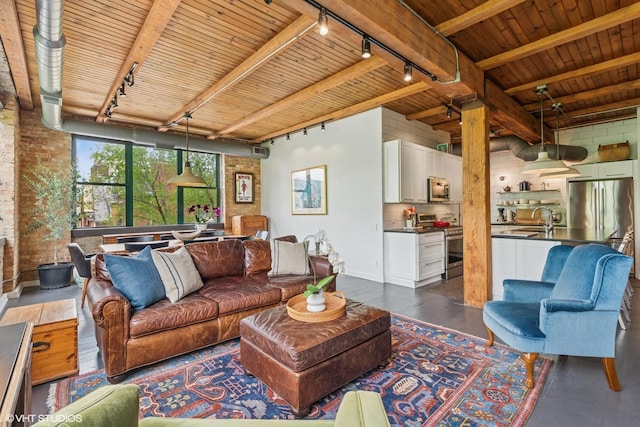 835 N Wood St Unit 301, Chicago, IL 60622 - living room featuring track lighting, a wooden ceiling with exposed beams, dark wood-style floors, and brick wall