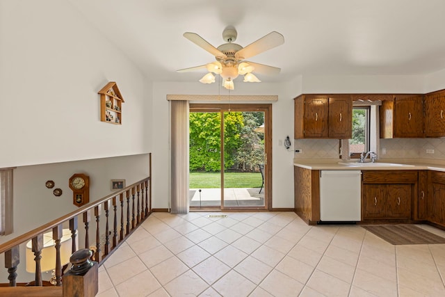 12026 Somerset Rd, Orland Park, IL 60467 - kitchen with white dishwasher, light countertops, plenty of natural light, and decorative backsplash