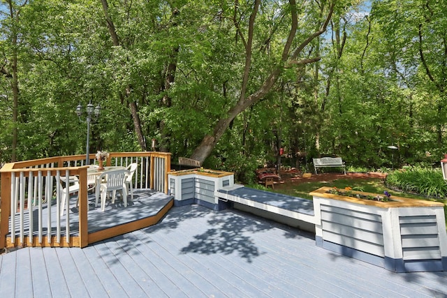688 Fox Holw, Dekalb, IL 60115 - wooden terrace featuring outdoor dining space and view of scattered trees