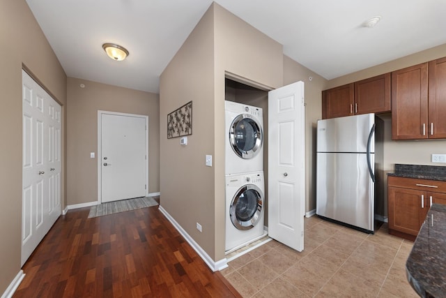 935 Burlington Ave Unit 411, Downers Grove, IL 60515 - laundry area with stacked washing machine and dryer and light wood-type flooring