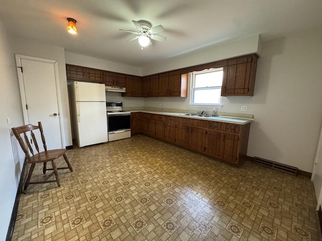 1106 Frederick St, Joliet, IL 60435 - kitchen featuring white appliances, light countertops, a ceiling fan, and under cabinet range hood