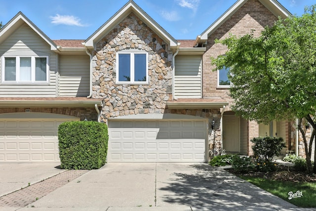 240 Taylor Ct, Buffalo Grove, IL 60089 - view of front facade with concrete driveway, stone siding, and a garage