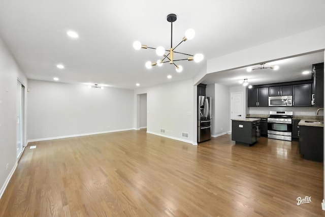 240 Taylor Ct, Buffalo Grove, IL 60089 - unfurnished living room with a chandelier, wood finished floors, and recessed lighting