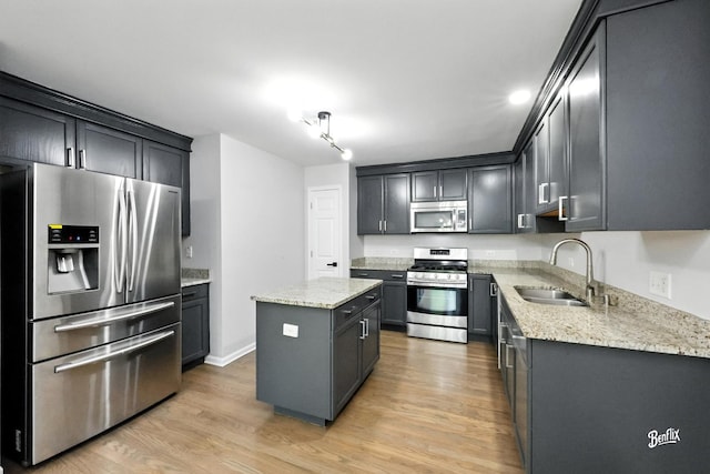 240 Taylor Ct, Buffalo Grove, IL 60089 - kitchen with appliances with stainless steel finishes, a center island, light wood-style flooring, and light stone countertops