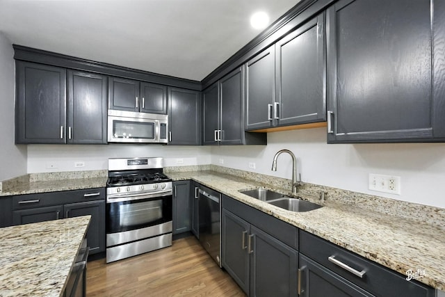 240 Taylor Ct, Buffalo Grove, IL 60089 - kitchen featuring appliances with stainless steel finishes, wood finished floors, and light stone countertops