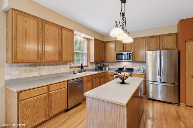 5 N Chestnut Ct, Hawthorn Woods, IL 60047 - kitchen featuring appliances with stainless steel finishes, light wood finished floors, tasteful backsplash, light countertops, and pendant lighting
