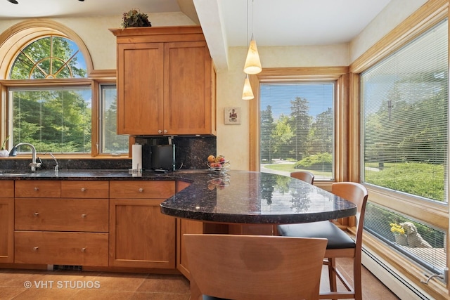 130 Old Dundee Rd, Barrington Hills, IL 60010 - kitchen with brown cabinets, plenty of natural light, and dark stone counters