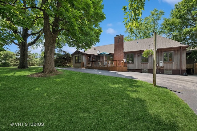 130 Old Dundee Rd, Barrington Hills, IL 60010 - back of property with a wooden deck, a chimney, a lawn, and a shingled roof