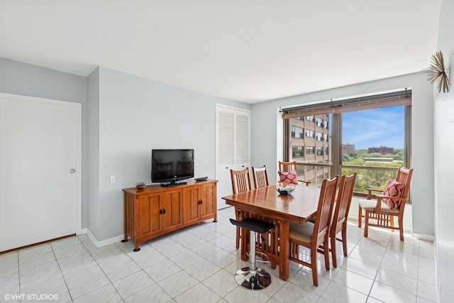 5050 S E End Ave Unit 9C, Chicago, IL 60615 - dining area featuring baseboards and light tile patterned flooring