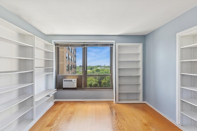 5050 S E End Ave Unit 9C, Chicago, IL 60615 - unfurnished room featuring wood finished floors and cooling unit