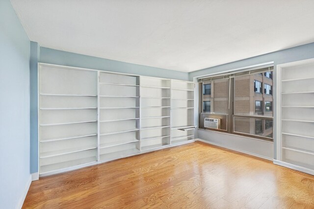 5050 S E End Ave Unit 9C, Chicago, IL 60615 - unfurnished room with wood finished floors and cooling unit