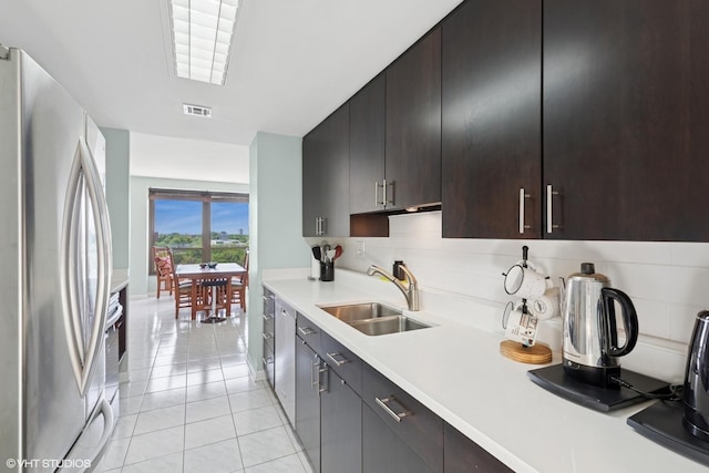 5050 S E End Ave Unit 9C, Chicago, IL 60615 - kitchen with stainless steel appliances, tasteful backsplash, light countertops, and light tile patterned flooring