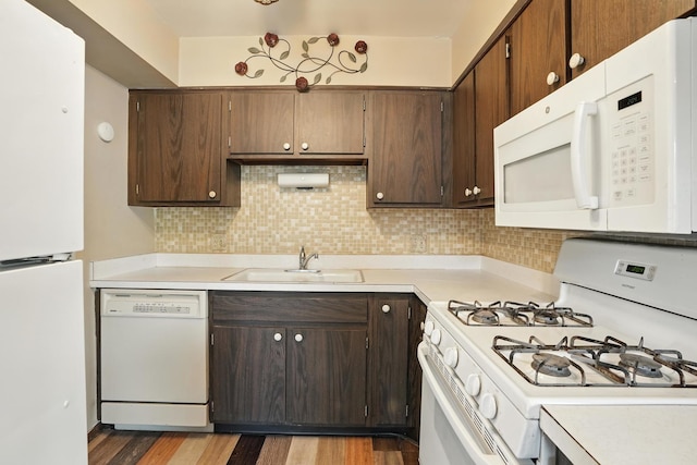 18205 Hart Dr Unit 2B, Homewood, IL 60430 - kitchen with white appliances, light countertops, light wood-style floors, backsplash, and dark brown cabinets