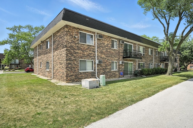 18205 Hart Dr Unit 2B, Homewood, IL 60430 - view of side of home with a yard, a balcony, and brick siding