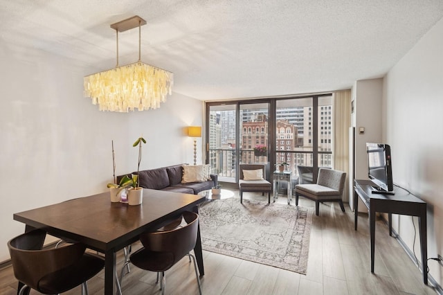 10 E Ontario St Unit 1304, Chicago, IL 60611 - dining room featuring wood finished floors, a chandelier, expansive windows, and a textured ceiling