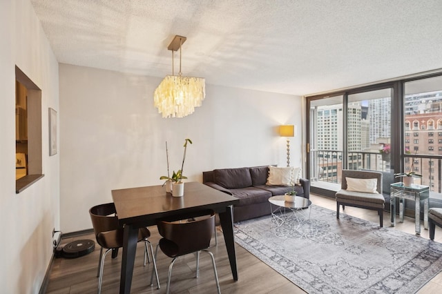 10 E Ontario St Unit 1304, Chicago, IL 60611 - living room with a textured ceiling, a chandelier, wood finished floors, and a wall of windows