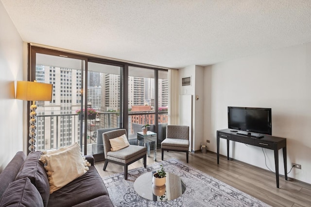 10 E Ontario St Unit 1304, Chicago, IL 60611 - living room featuring a textured ceiling, expansive windows, wood finished floors, and plenty of natural light