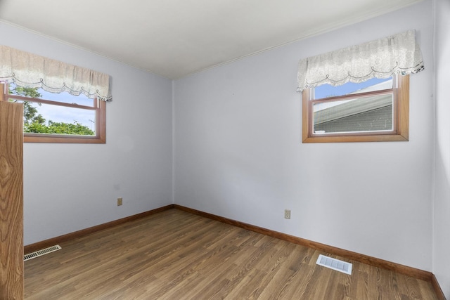 2306 Webster Ave, Joliet, IL 60436 - spare room with ornamental molding, wood finished floors, and plenty of natural light