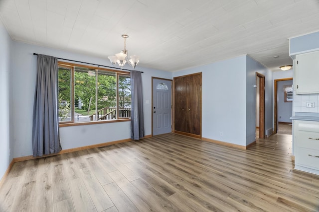 2306 Webster Ave, Joliet, IL 60436 - empty room featuring a chandelier and light wood-style flooring