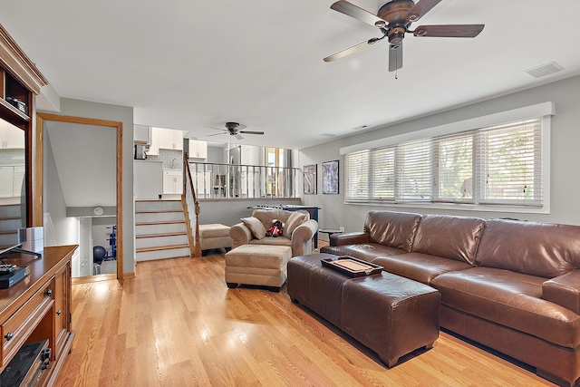 8941 Timothy Ct, Orland Park, IL 60462 - living area with ceiling fan, light wood finished floors, and stairway