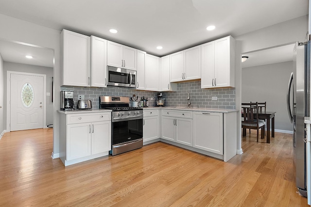 8941 Timothy Ct, Orland Park, IL 60462 - kitchen featuring appliances with stainless steel finishes, light countertops, tasteful backsplash, light wood-style floors, and recessed lighting
