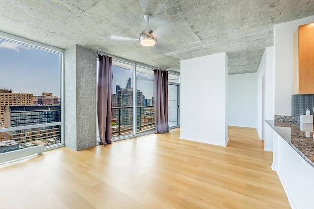 611 S Wells St Unit 2301, Chicago, IL 60607 - spare room featuring a view of city, light wood-style flooring, expansive windows, and healthy amount of natural light