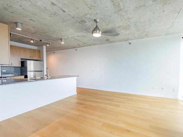 611 S Wells St Unit 2301, Chicago, IL 60607 - kitchen featuring freestanding refrigerator, light wood-type flooring, dark stone counters, and brown cabinets