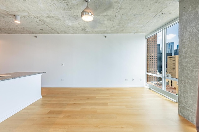 611 S Wells St Unit 2301, Chicago, IL 60607 - spare room featuring light wood-style floors, expansive windows, and a city view