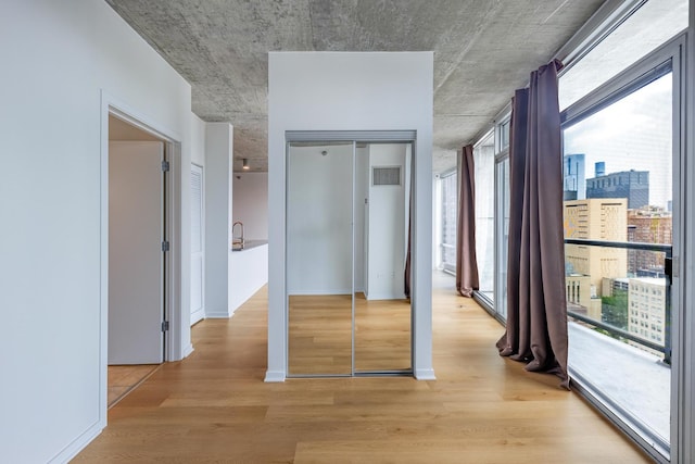 611 S Wells St Unit 2301, Chicago, IL 60607 - unfurnished bedroom with multiple windows, light wood-type flooring, a closet, and a view of city