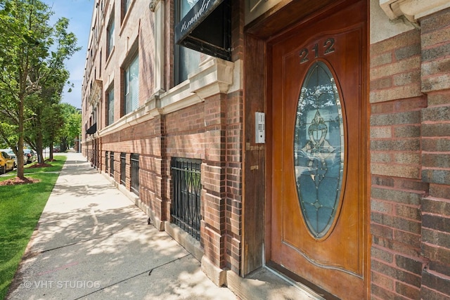 212 E 44th St Unit 2, Chicago, IL 60653 - doorway to property featuring brick siding