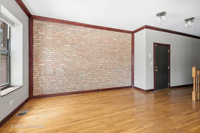 212 E 44th St Unit 2, Chicago, IL 60653 - empty room featuring brick wall, light wood finished floors, and ornamental molding