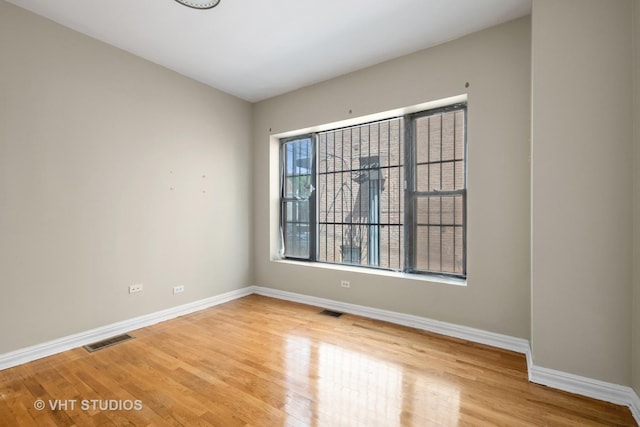 212 E 44th St Unit 2, Chicago, IL 60653 - spare room featuring baseboards and light wood finished floors
