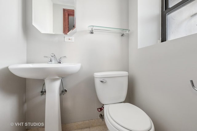 212 E 44th St Unit 2, Chicago, IL 60653 - half bathroom featuring toilet and baseboards