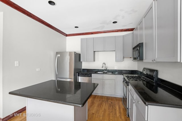 212 E 44th St Unit 2, Chicago, IL 60653 - kitchen featuring stainless steel appliances, light wood-style flooring, recessed lighting, a kitchen island, and dark stone countertops