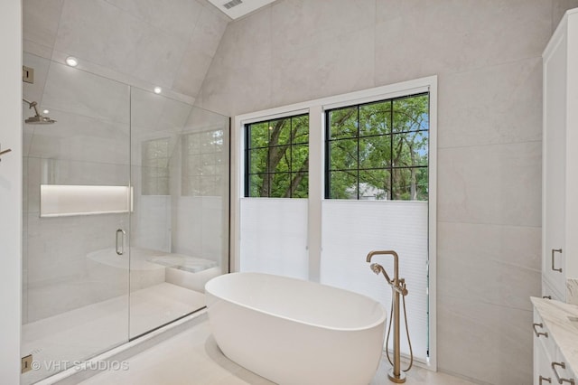 759 Strawberry Hill Dr, Glencoe, IL 60022 - full bath with a shower stall, tile walls, a soaking tub, and vanity