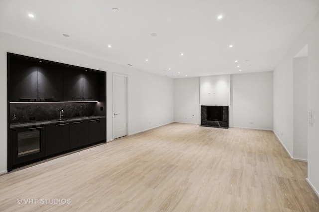 759 Strawberry Hill Dr, Glencoe, IL 60022 - unfurnished living room with light wood-style flooring, a fireplace, and recessed lighting