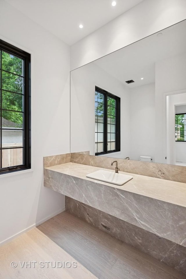 759 Strawberry Hill Dr, Glencoe, IL 60022 - bathroom with healthy amount of natural light, wood finished floors, recessed lighting, and vanity