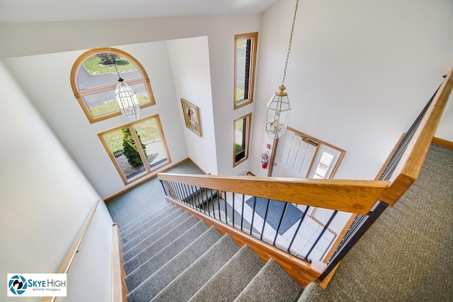 10825 Kathleen Ct Unit D, Palos Hills, IL 60465 - stairs featuring carpet floors, a high ceiling, and a chandelier