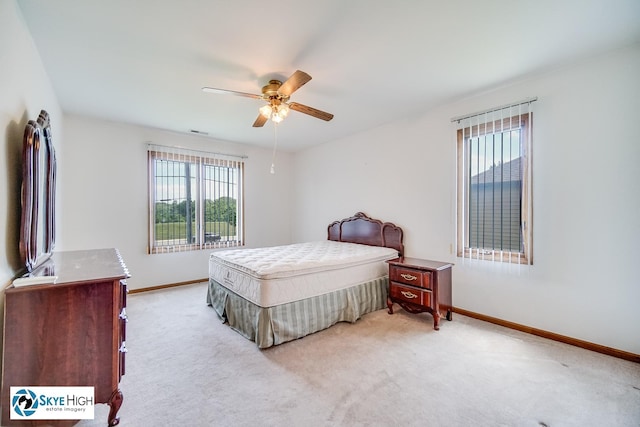 10825 Kathleen Ct Unit D, Palos Hills, IL 60465 - bedroom with multiple windows, light colored carpet, and a ceiling fan