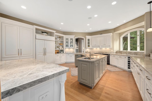 8698 S Madison St, Burr Ridge, IL 60527 - kitchen featuring open shelves, a kitchen island with sink, stainless steel dishwasher, white cabinets, and recessed lighting