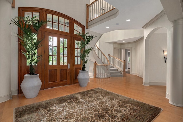 8698 S Madison St, Burr Ridge, IL 60527 - foyer entrance with decorative columns, stairs, wood finished floors, recessed lighting, and crown molding