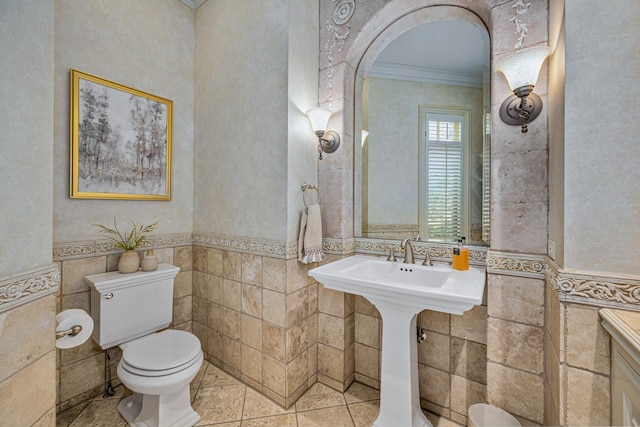 8698 S Madison St, Burr Ridge, IL 60527 - half bathroom featuring crown molding, tile walls, tile patterned flooring, and wainscoting